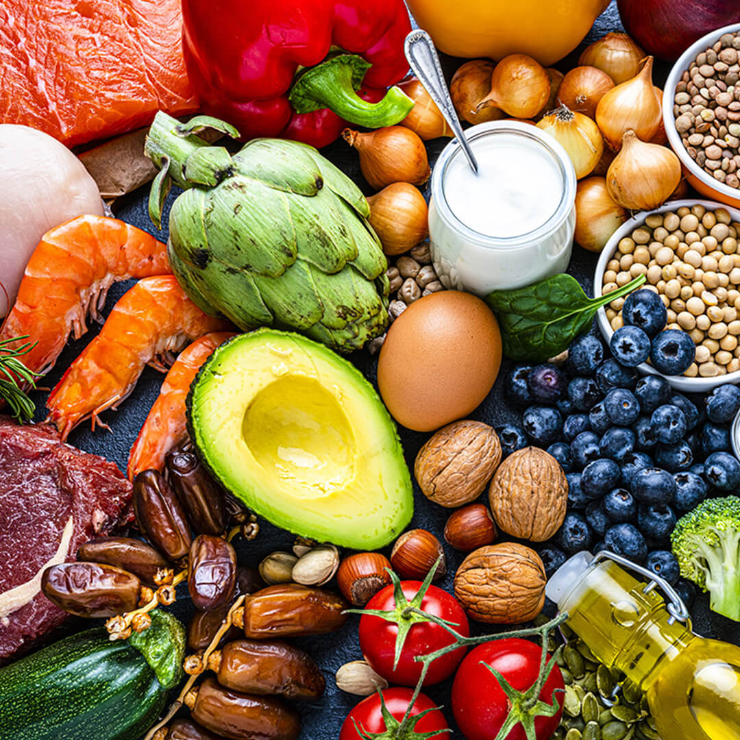Various healthy foods for cancer patients, including fruits, vegetables, and seafood